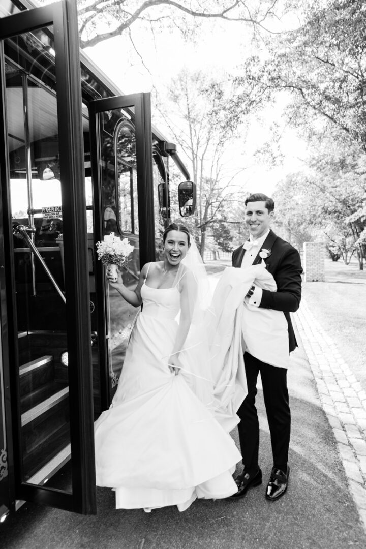 A groom and a bride boarding a bus