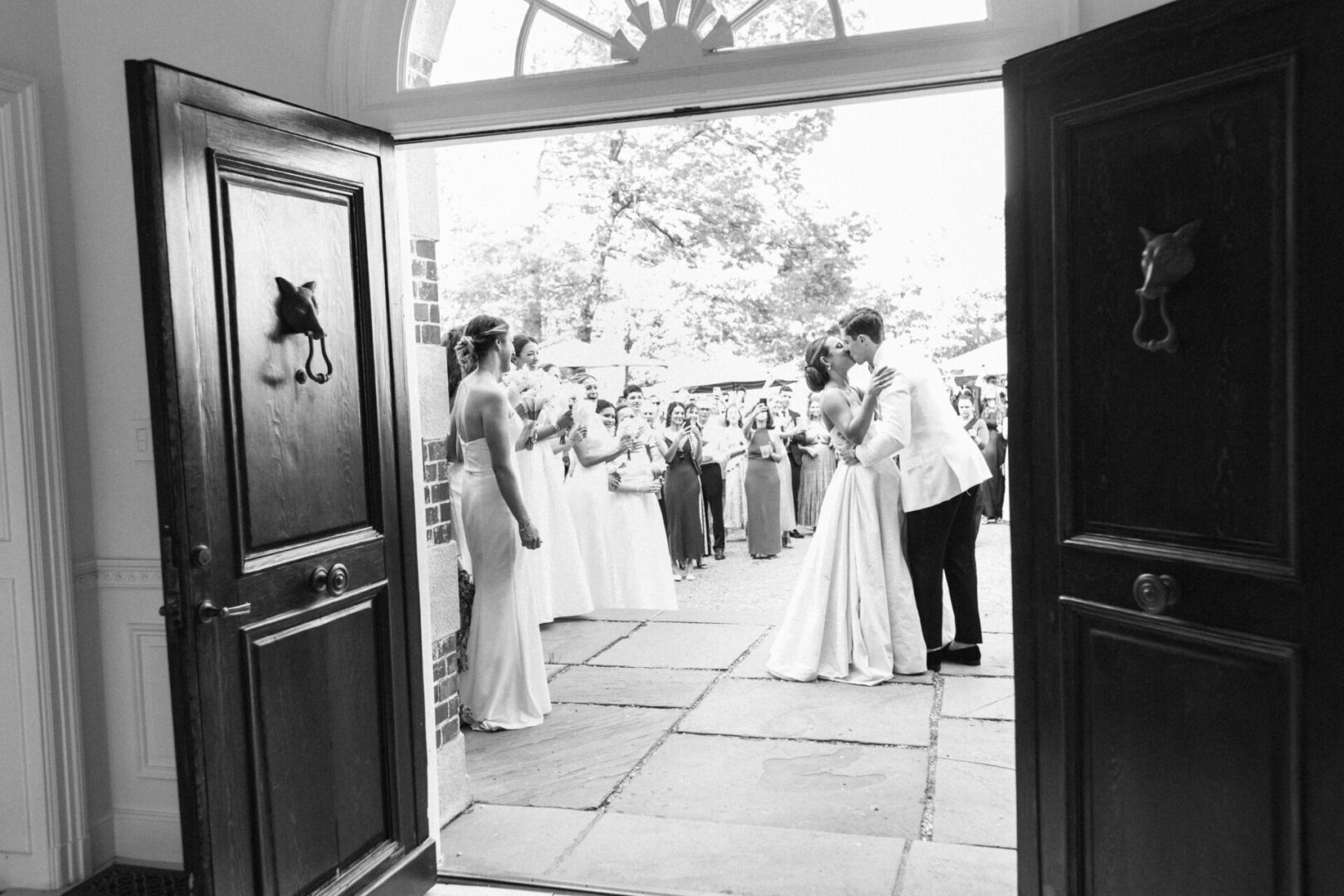 The bride and the groom kissing at the entrance of church
