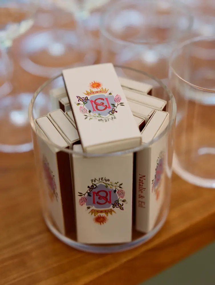 A glass filled of match boxes on a table