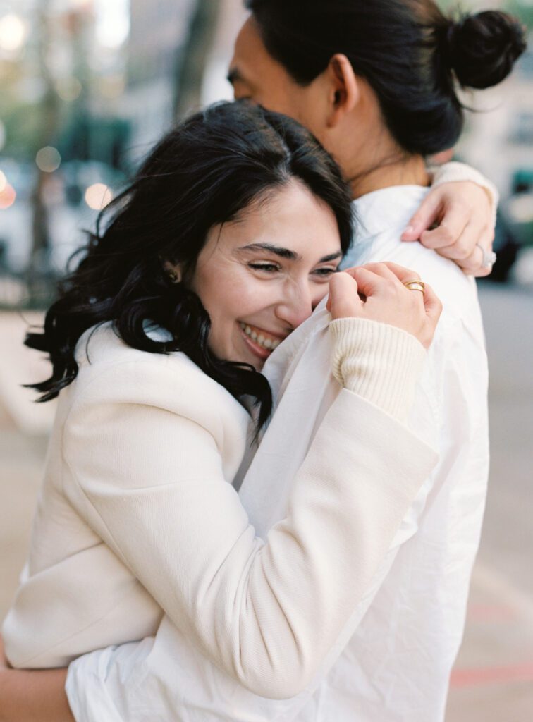 A girl hugging a guy on the street