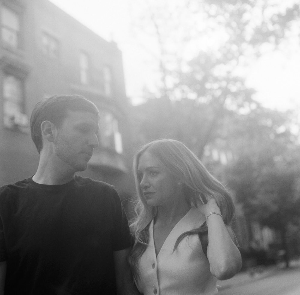 Black and white image of a couple walking on the street
