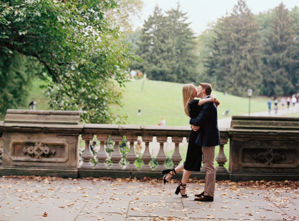 A couple kissing each other inside a park