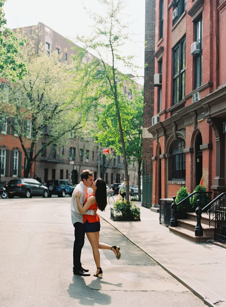 A boy and a girl kissing each other on the street