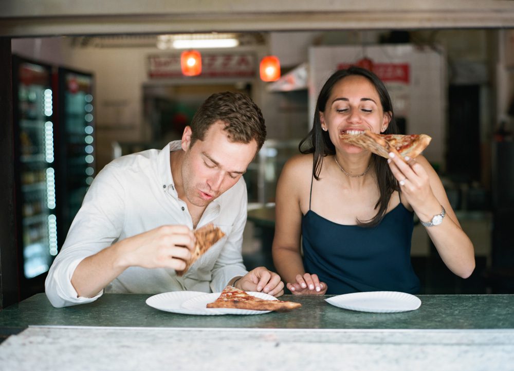 A couple posing while eating food