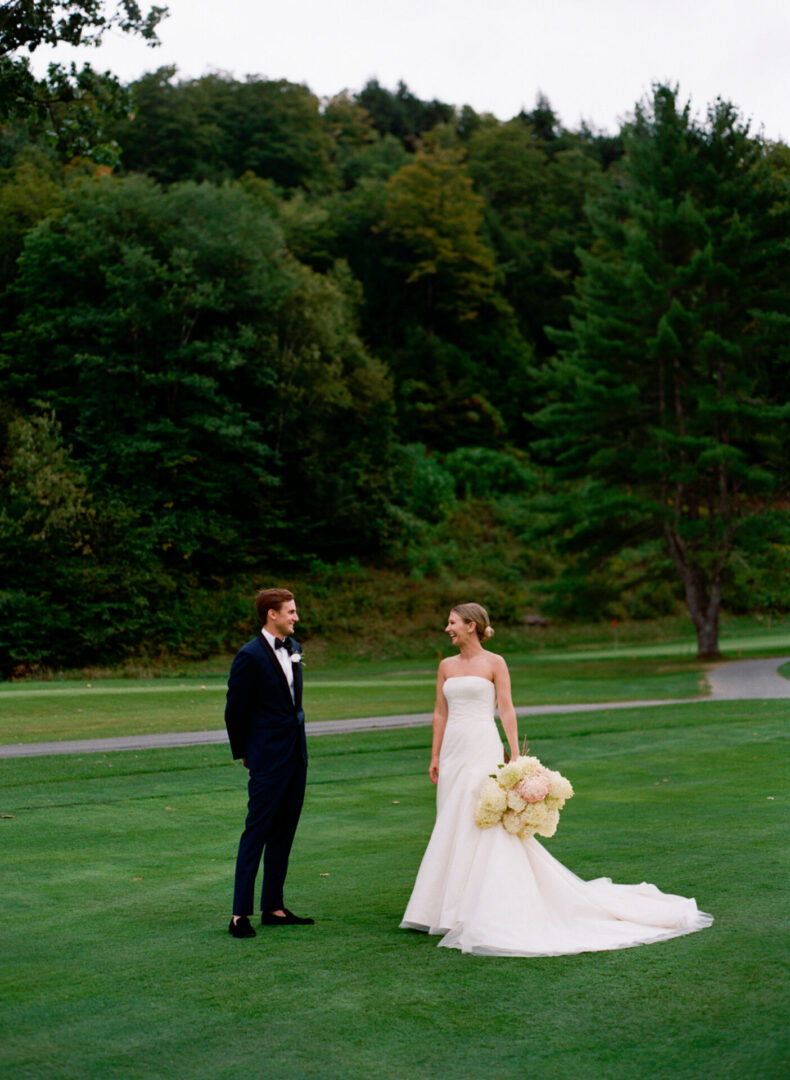 Bride and Groom looking lovingly at one another on a golf course