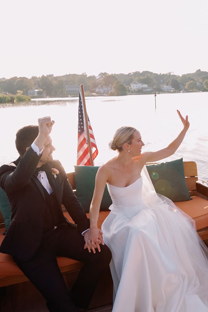 Couple Waving on Boat